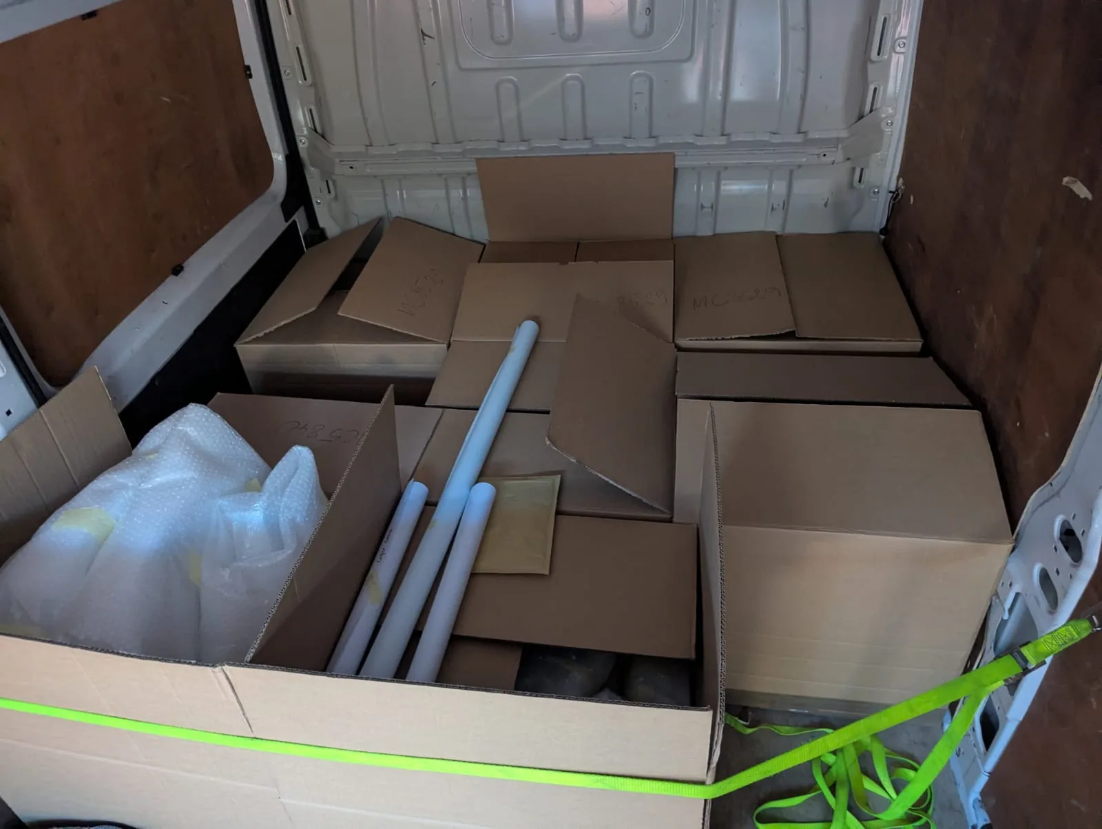 Mixed boxed commercial goods secured in the Arrow delivery van