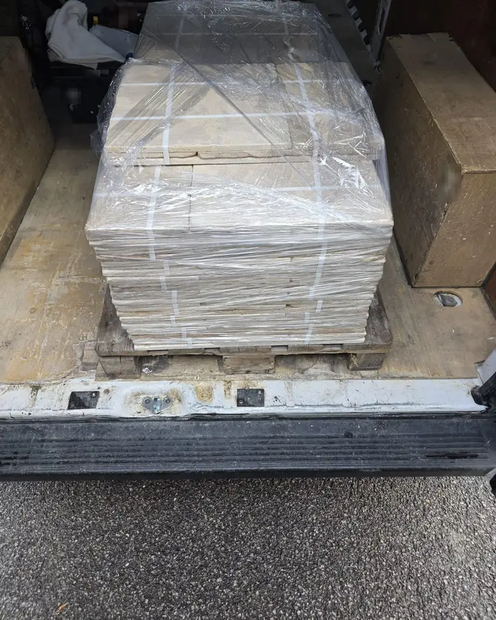 A wrapped and strapped pallet of tiles in the Arrow van