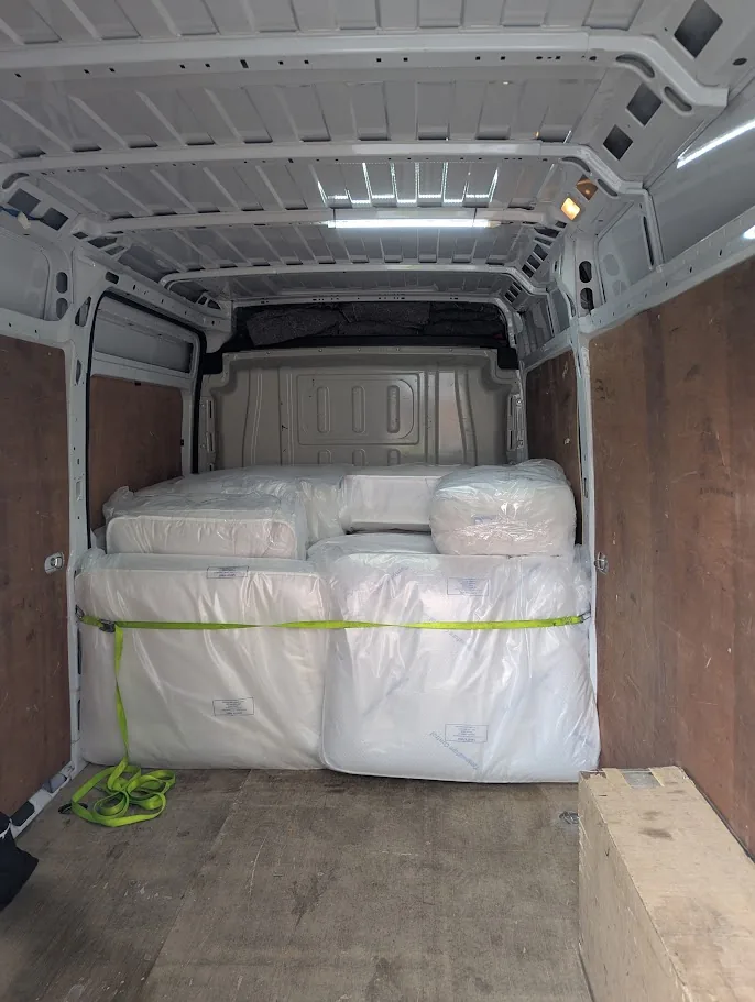 Mattress samples protected and secured inside the delivery van
